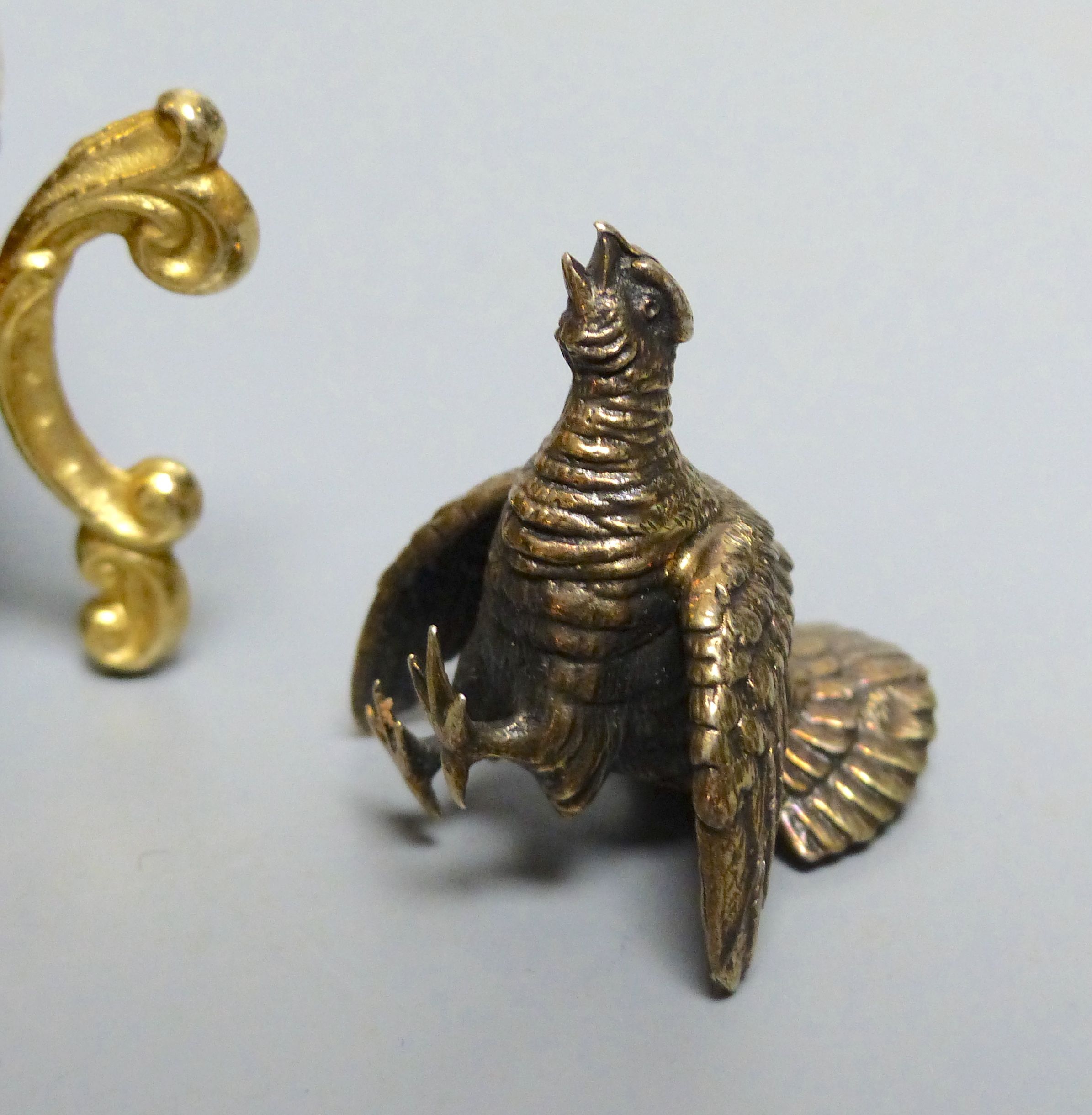 A modern silver gilt surprise egg, by Richard Lawrence Geere, London, 1975, on stand & a model of a fighting cock.